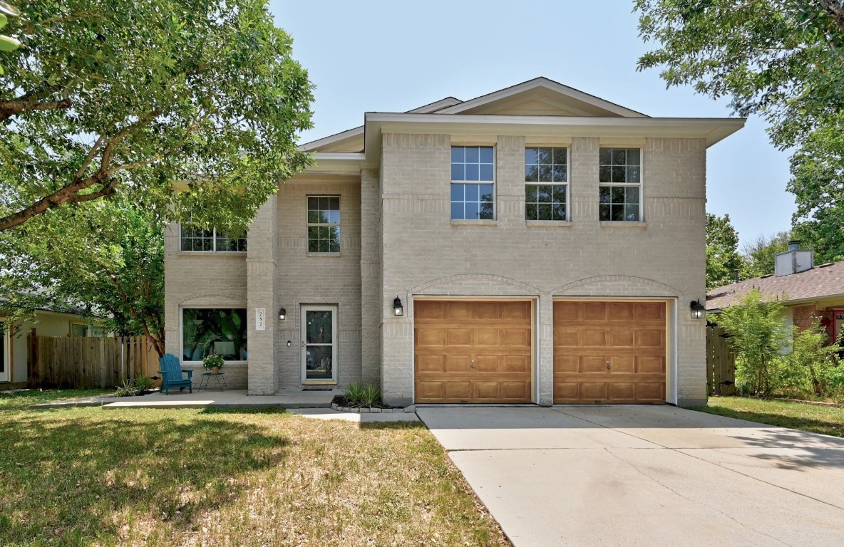a front view of a house with a yard and garage