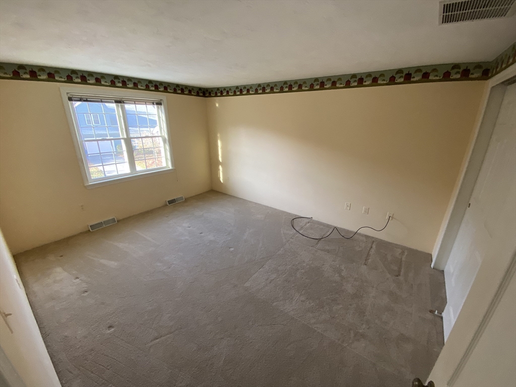 501 Ridgefield Circle, Unit B Clinton, MA 01510 - Photo 12 of 17 a view of a room with window and a ceiling fan