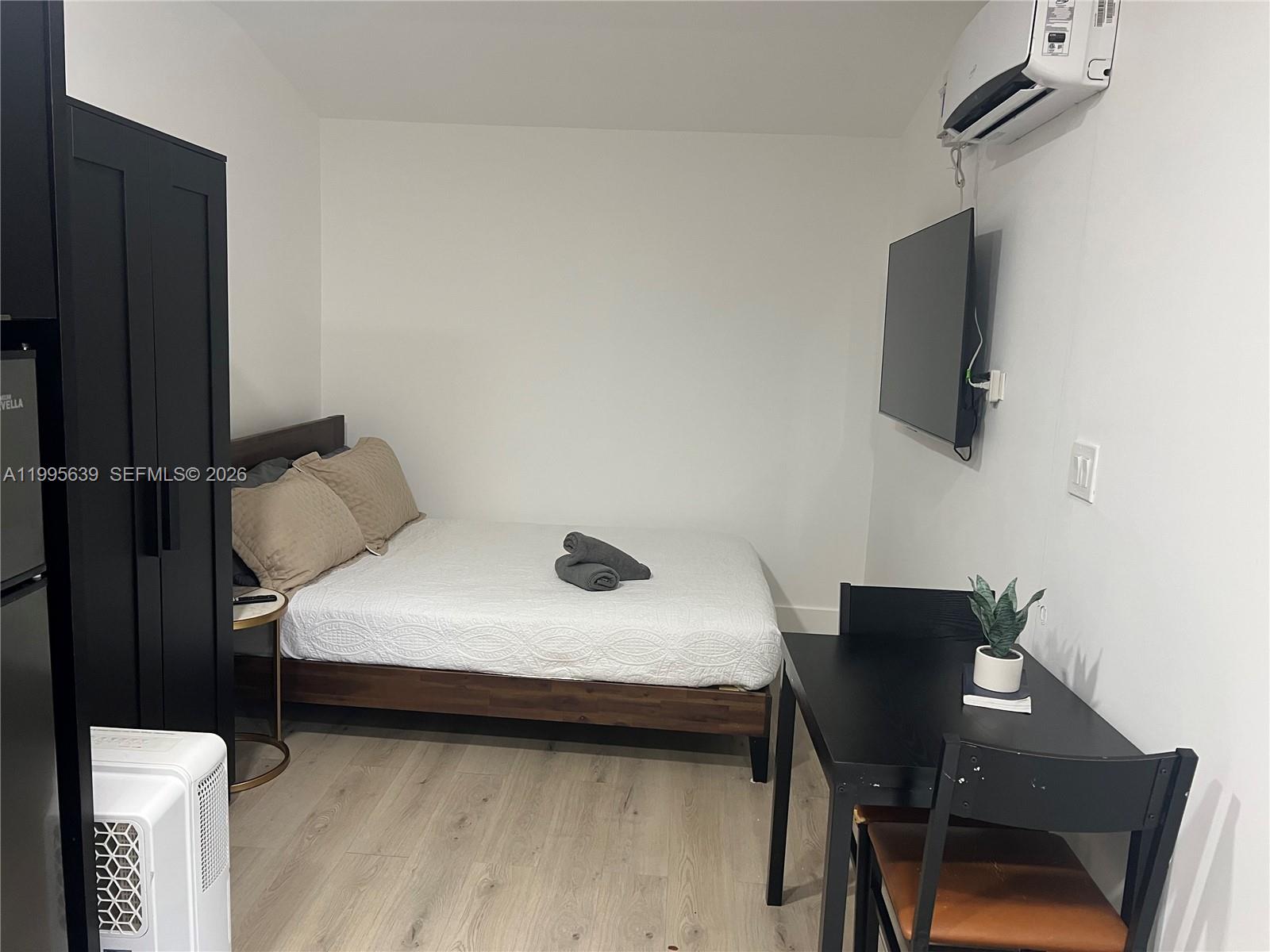2723 Southwest 13th Street, Unit STUDIO Miami, FL 33135 - Photo 3 of 10 a bedroom with a bed and a chair