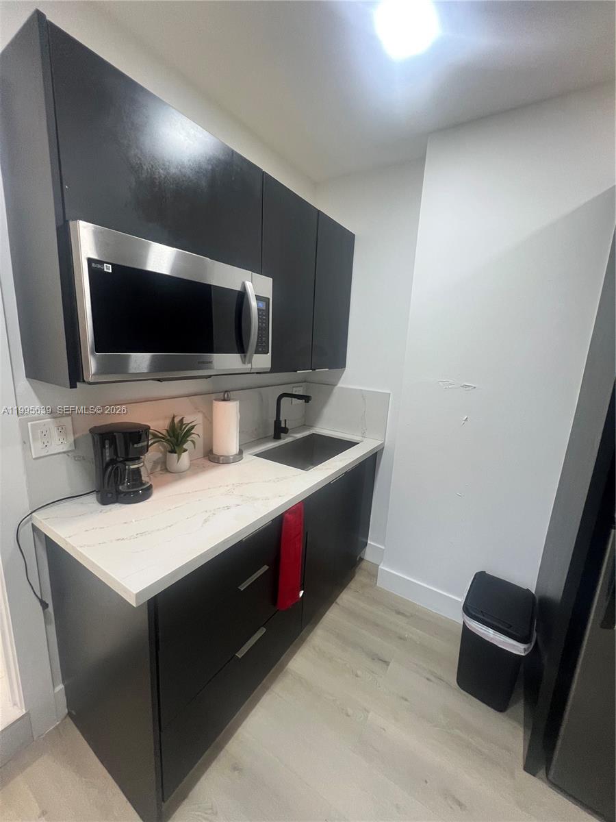 2723 Southwest 13th Street, Unit STUDIO Miami, FL 33135 - Photo 6 of 10 a kitchen with a stove and a microwave