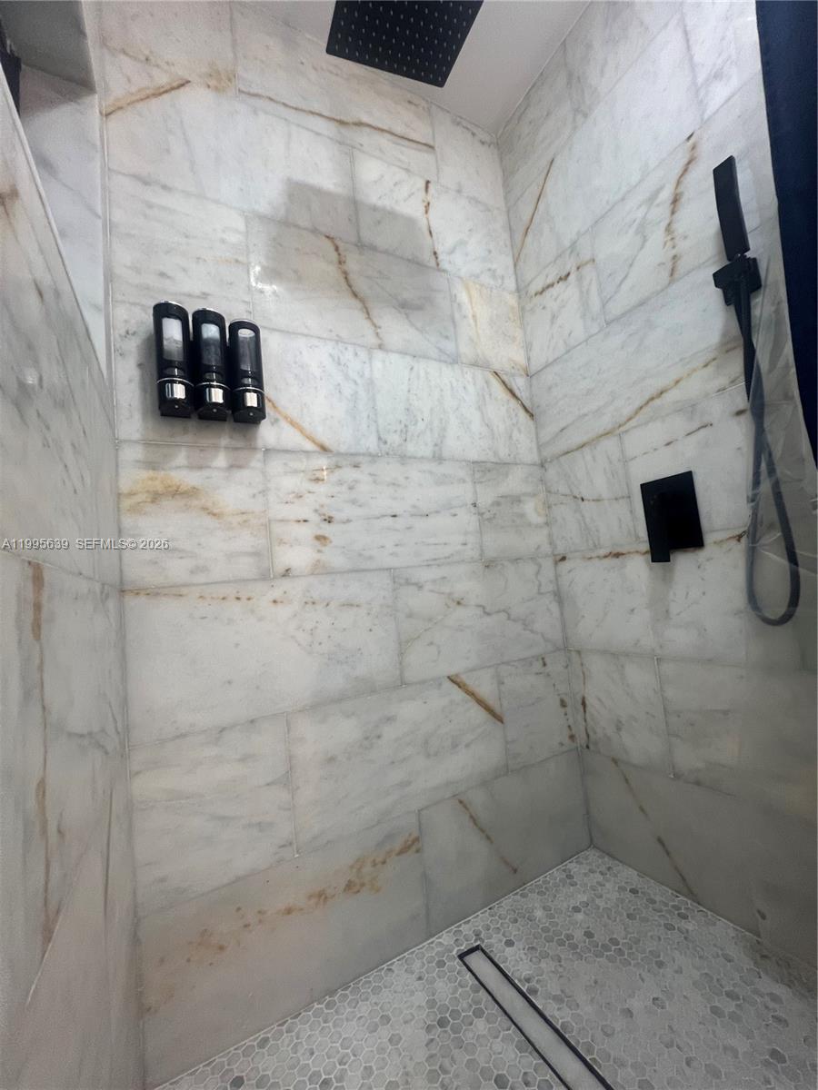 2723 Southwest 13th Street, Unit STUDIO Miami, FL 33135 - Photo 7 of 10 a bathroom with a sink and a shower