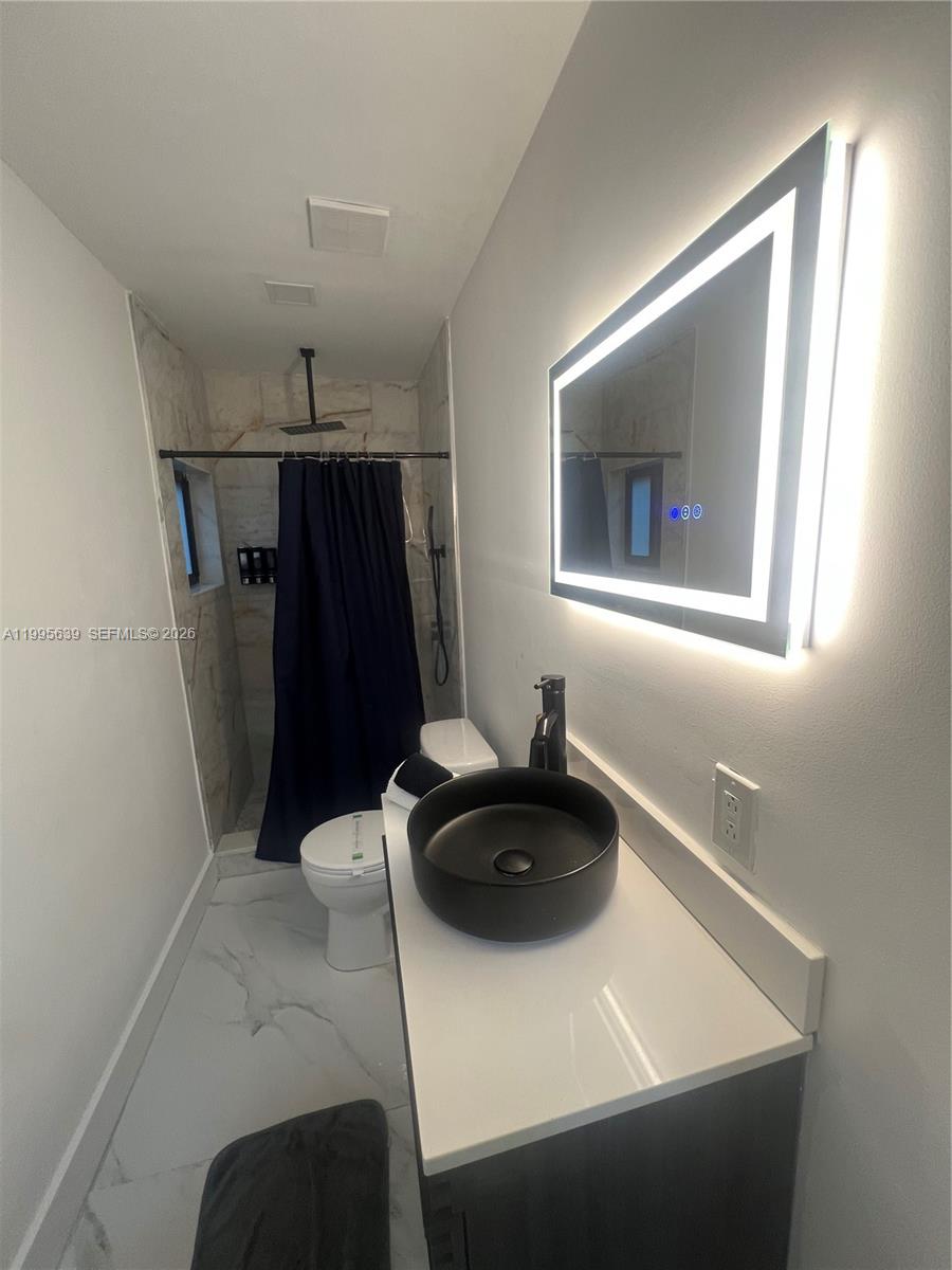 2723 Southwest 13th Street, Unit STUDIO Miami, FL 33135 - Photo 8 of 10 a kitchen with a sink and a refrigerator