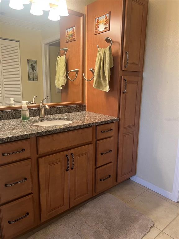 220 Coldeway Drive, Unit 123 Punta Gorda, FL 33950 - Photo 14 of 59 a bathroom with a granite countertop sink and a mirror