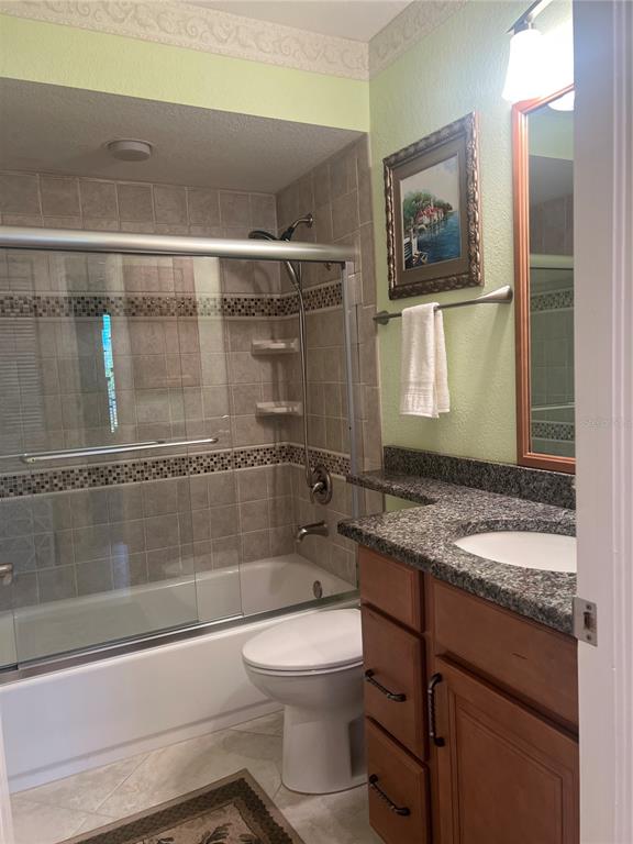 220 Coldeway Drive, Unit 123 Punta Gorda, FL 33950 - Photo 19 of 59 a bathroom with a granite countertop toilet sink and mirror