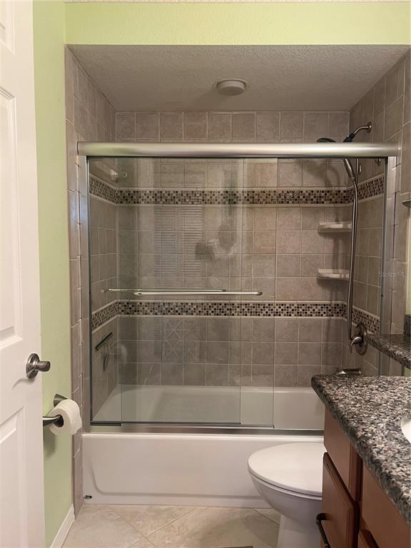 220 Coldeway Drive, Unit 123 Punta Gorda, FL 33950 - Photo 20 of 59 a bathroom with a granite countertop bathtub shower sink vanity and toilet