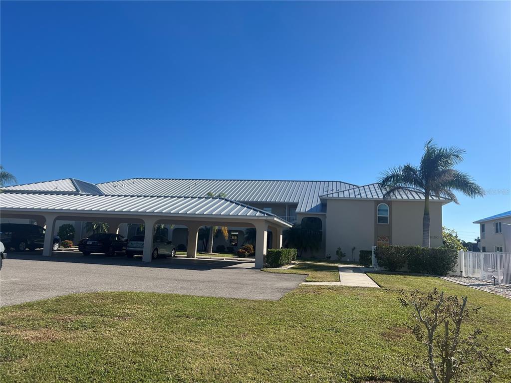220 Coldeway Drive, Unit 123 Punta Gorda, FL 33950 - Photo 2 of 59 a view of a house with swimming pool and a yard