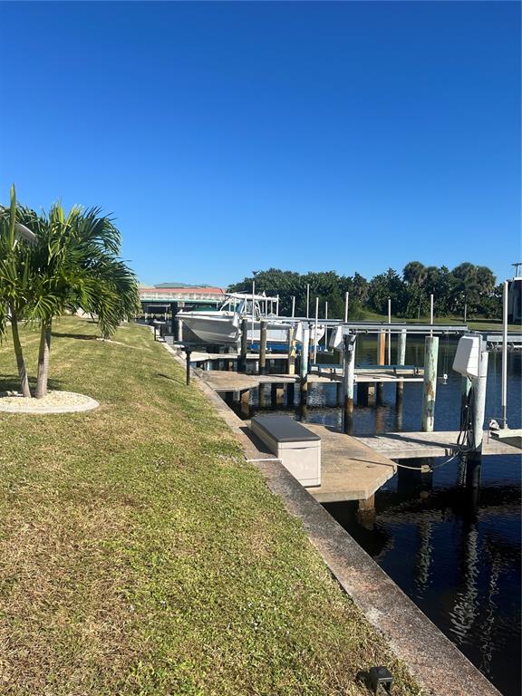 220 Coldeway Drive, Unit 123 Punta Gorda, FL 33950 - Photo 24 of 59 a view of a swimming pool with a table and chairs a fire pit