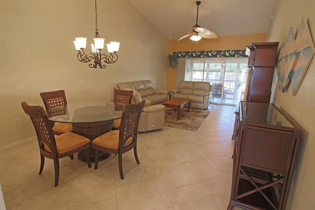 220 Coldeway Drive, Unit 123 Punta Gorda, FL 33950 - Photo 42 of 59 a view of a dining room with furniture wooden floor and chandelier