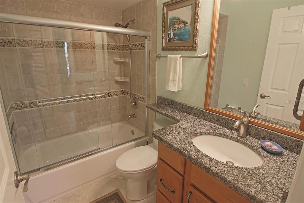 220 Coldeway Drive, Unit 123 Punta Gorda, FL 33950 - Photo 47 of 59 a bathroom with a granite countertop sink toilet and shower