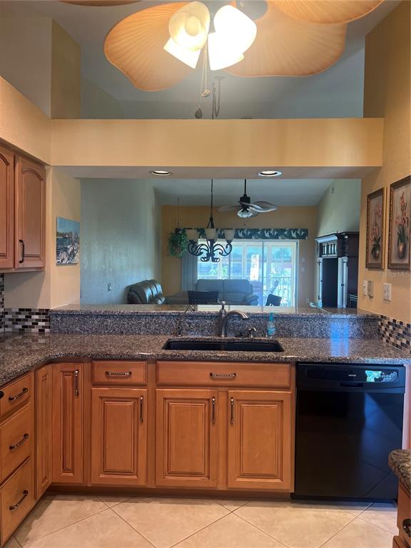 220 Coldeway Drive, Unit 123 Punta Gorda, FL 33950 - Photo 5 of 59 a kitchen with granite countertop a sink and cabinets
