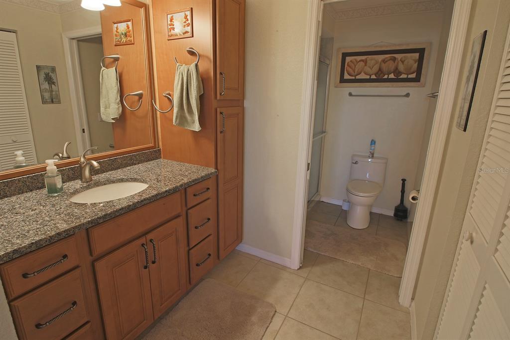 220 Coldeway Drive, Unit 123 Punta Gorda, FL 33950 - Photo 54 of 59 a bathroom with a granite countertop sink toilet and shower
