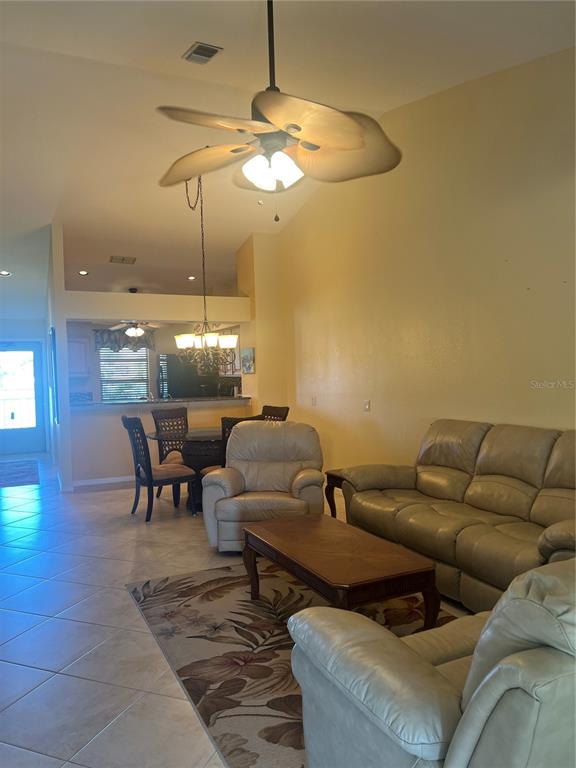220 Coldeway Drive, Unit 123 Punta Gorda, FL 33950 - Photo 8 of 59 a living room with furniture and a chandelier