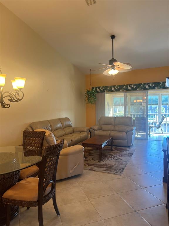 220 Coldeway Drive, Unit 123 Punta Gorda, FL 33950 - Photo 9 of 59 a room with furniture and a chandelier