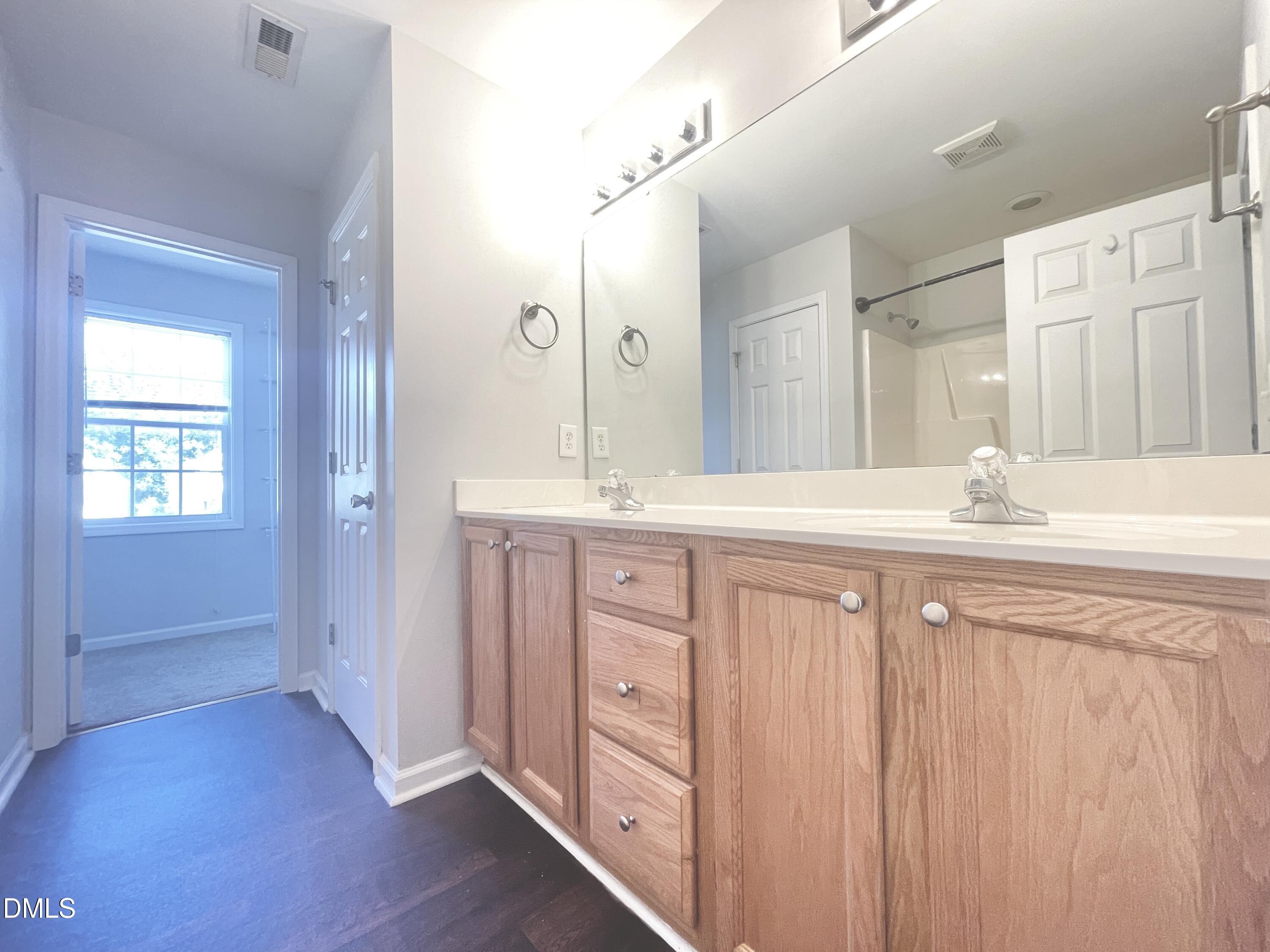 112 Taylors Creek Court Raleigh, NC 27610 - Photo 18 of 34 a bathroom with a double vanity sink and a mirror