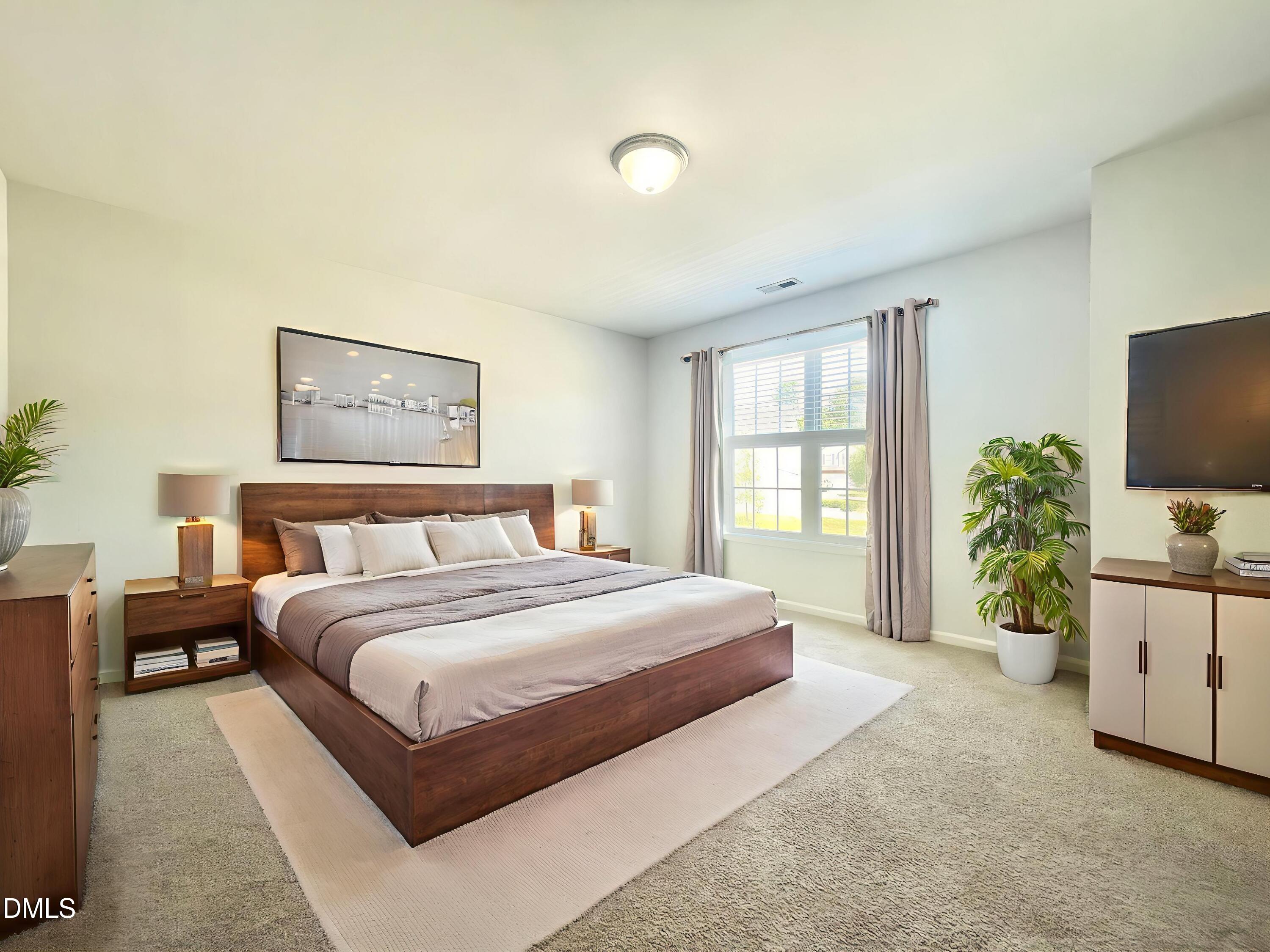 112 Taylors Creek Court Raleigh, NC 27610 - Photo 27 of 34 a spacious bedroom with a large bed and a flat tv screen on dresser