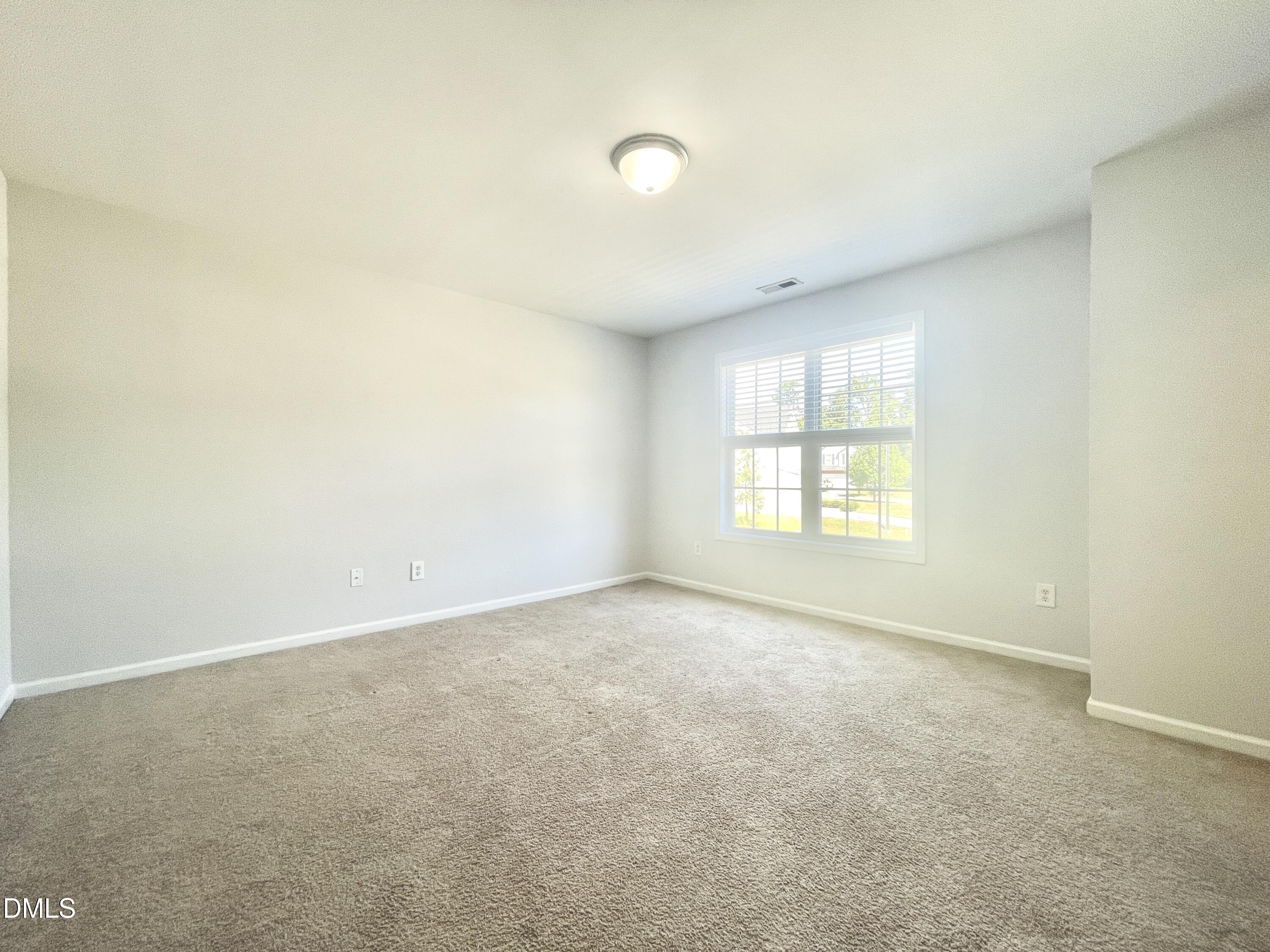 112 Taylors Creek Court Raleigh, NC 27610 - Photo 28 of 34 an empty room with windows and entrance