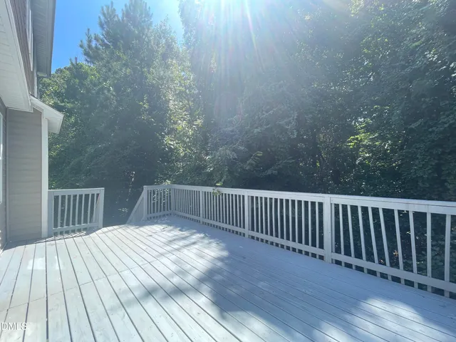 a view of a house with backyard and deck