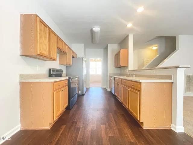 a view of a kitchen with a sink and a stove top oven