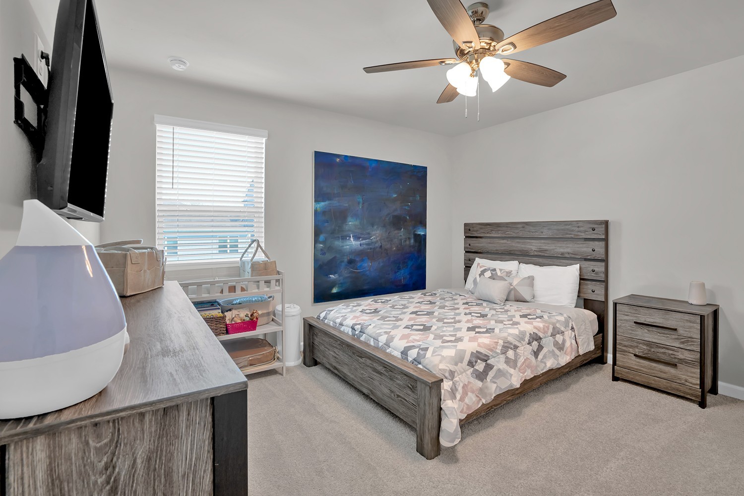 708 Pintail Pointe Lebanon, TN 37090 - Photo 27 of 41 a bedroom with a bed a chandelier and a flat screen tv
