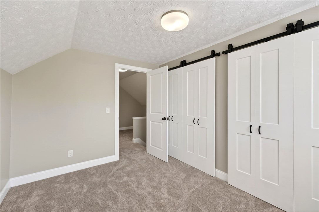 5975 Rosalie Road Dayton, OH 45424 - Photo 24 of 48 This cozy room offers convenient access with stylish barn doors and soft carpeting.