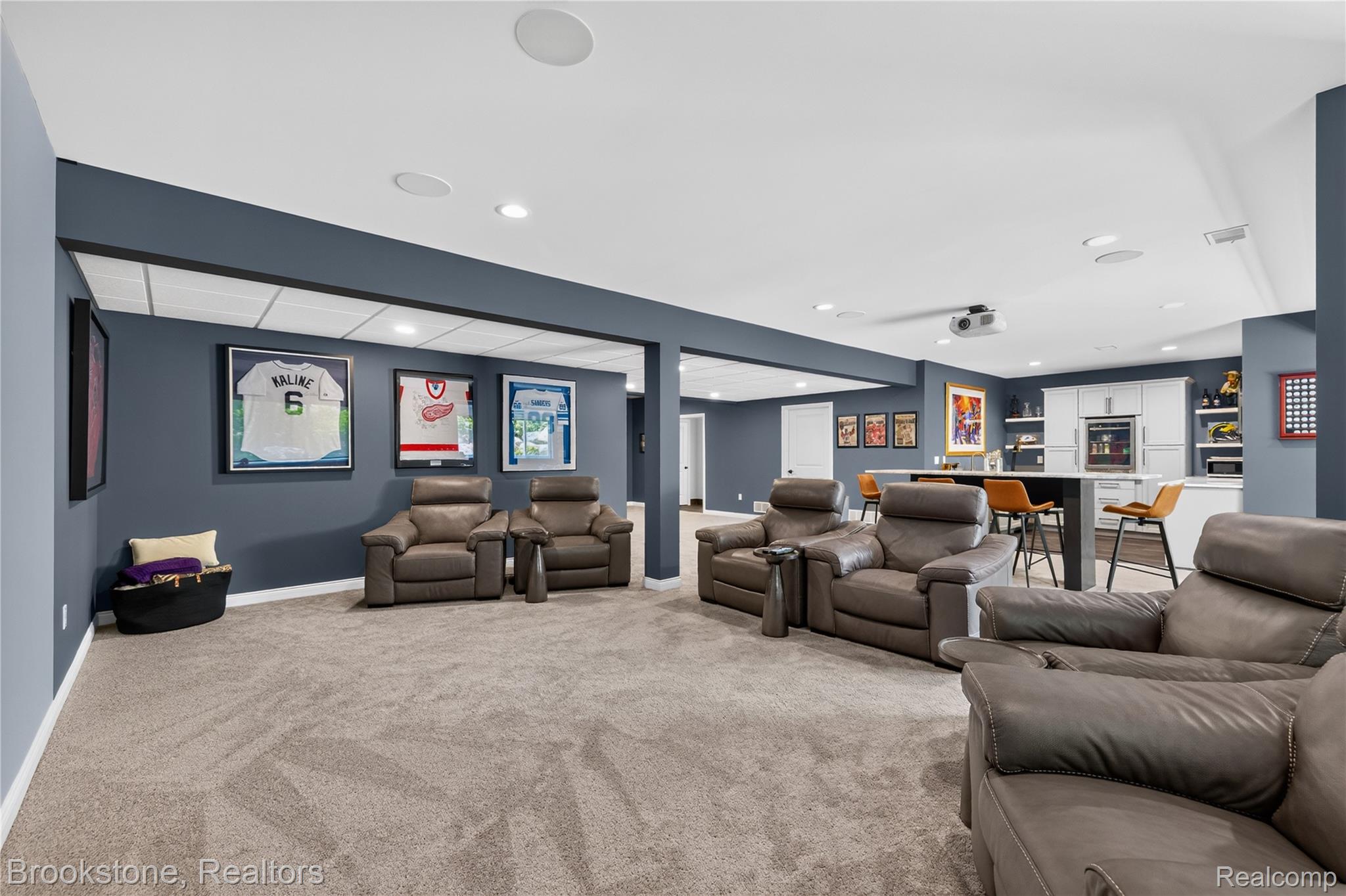 2167 Sanctuary Court Rochester, MI 48309 - Photo 61 of 68 Spacious entertainment area featuring recessed lighting, a projector, an integrated wet bar with white cabinetry, a built-in beverage refrigerator, and open shelving