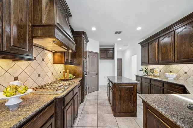 a kitchen with stainless steel appliances granite countertop a sink stove and cabinets
