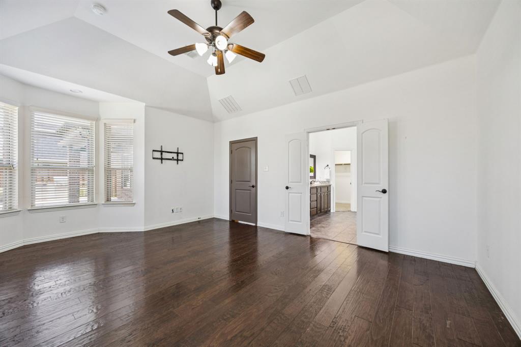 916 Redbird Lane Allen, TX 75013 - Photo 21 of 39 a view of an empty room with a window and wooden floor