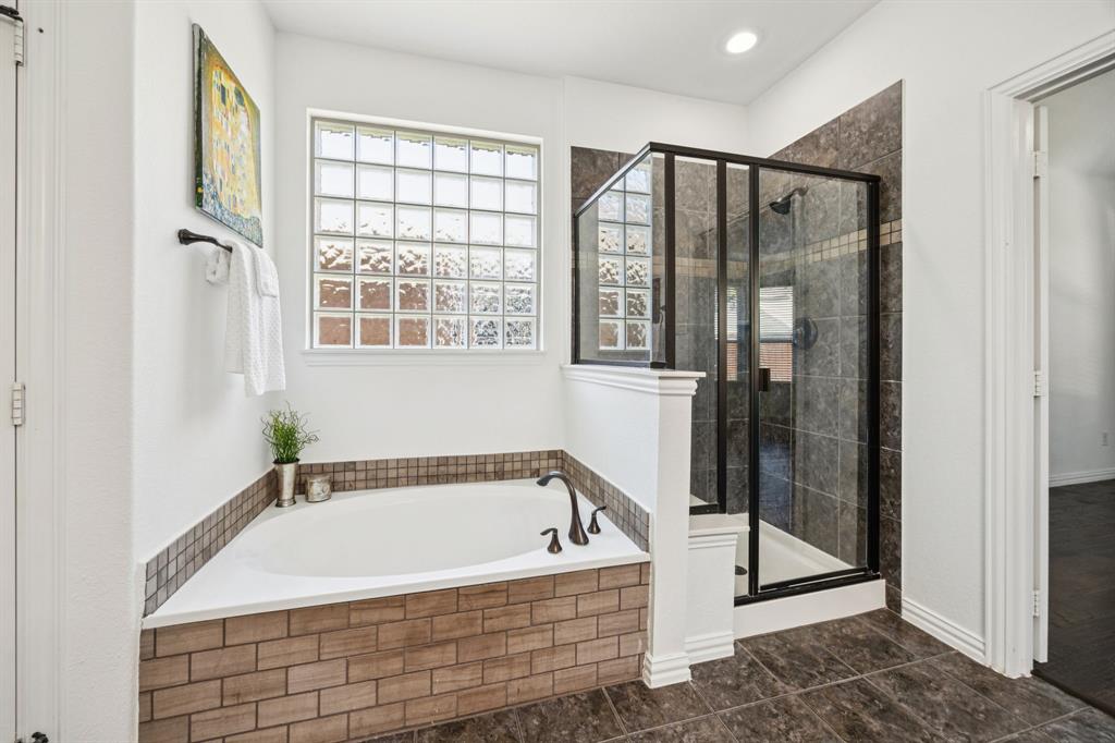 916 Redbird Lane Allen, TX 75013 - Photo 23 of 39 a bathroom with a bathtub and a shower