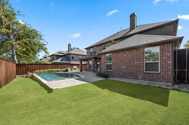 a front view of a house with a yard table and chairs