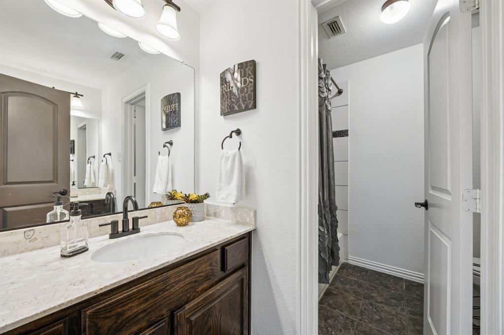 916 Redbird Lane Allen, TX 75013 - Photo 34 of 39 a bathroom with a sink double vanity and a mirror