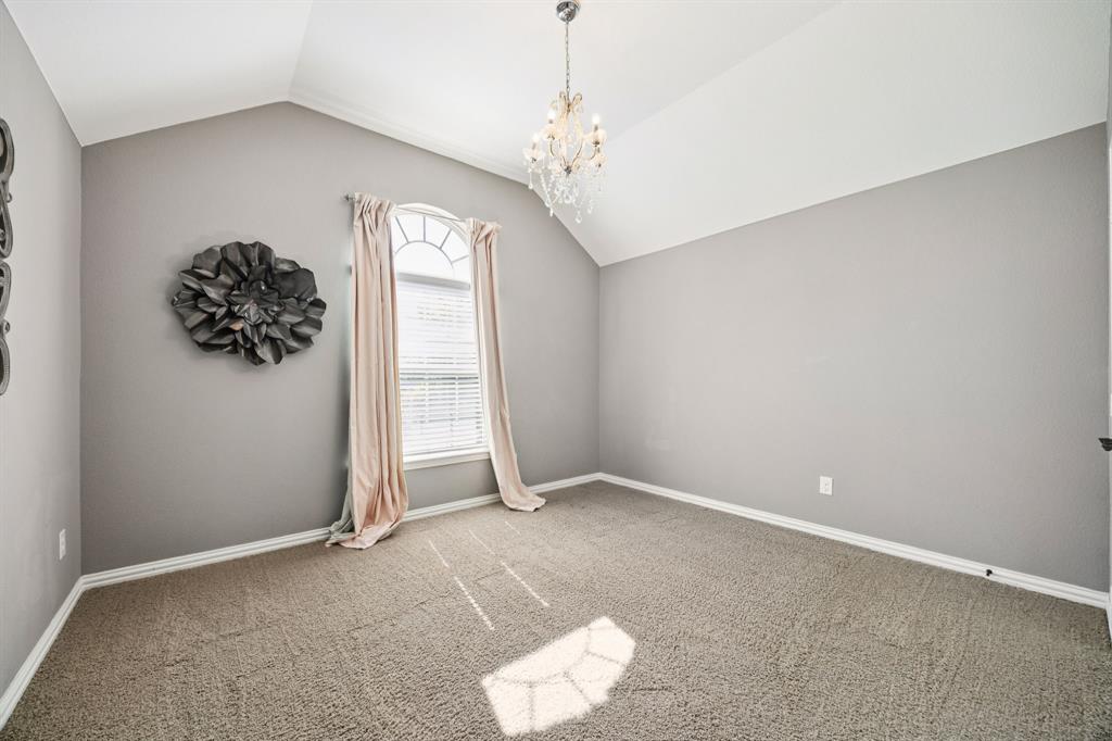 916 Redbird Lane Allen, TX 75013 - Photo 36 of 39 an empty room with windows and chandelier fan