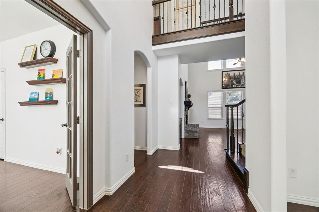 916 Redbird Lane Allen, TX 75013 - Photo 4 of 39 a view of hallway with wooden floor and stairs