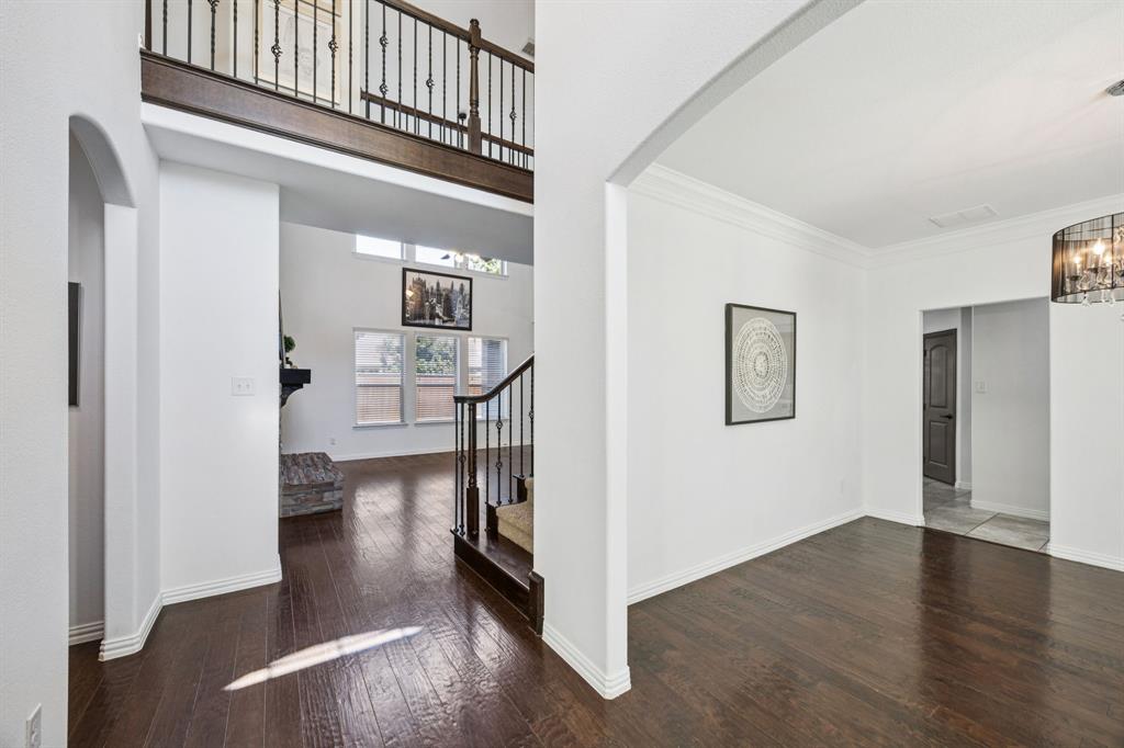 916 Redbird Lane Allen, TX 75013 - Photo 6 of 39 a view of a hallway with wooden floor and a living room