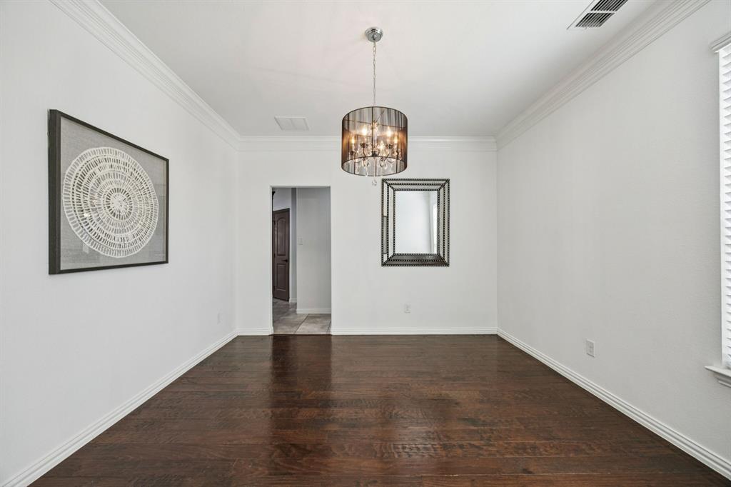 916 Redbird Lane Allen, TX 75013 - Photo 8 of 39 a view of a room with wooden floor chandelier and closet