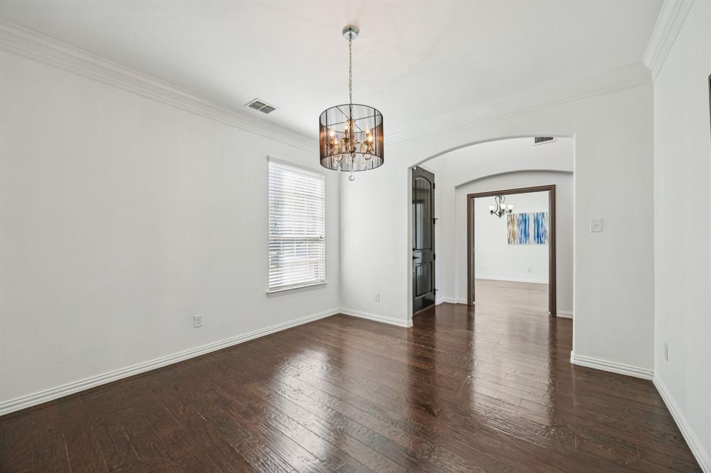 916 Redbird Lane Allen, TX 75013 - Photo 9 of 39 an empty room with wooden floor and windows