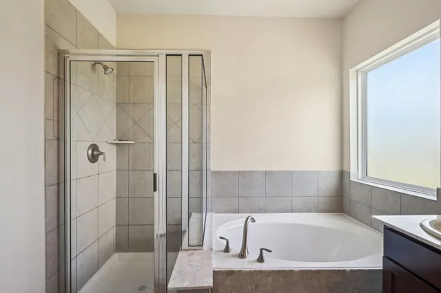 a bathroom with a tub and shower