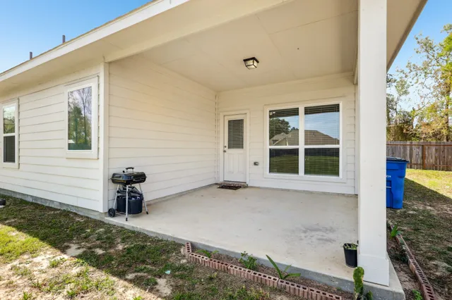 a view of a house with backyard porch and sitting area