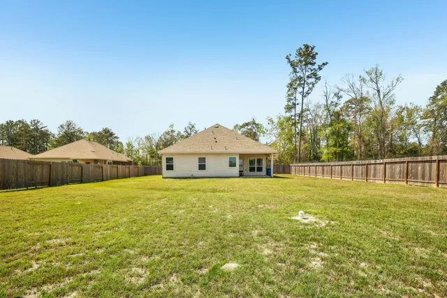 a big house with a big yard and large trees