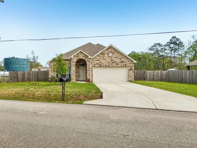 a front view of a house with a yard garage and garage