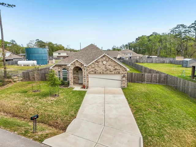 a view of a garden with large trees