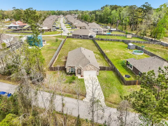 a view of a lake with a yard and trees