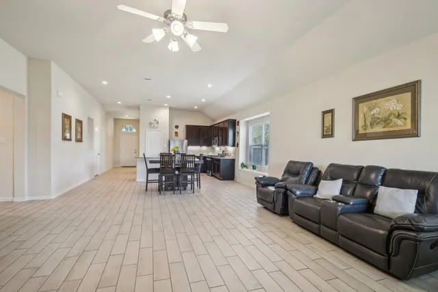 a living room with furniture and wooden floor