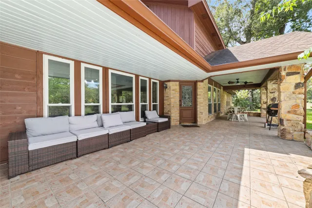 a view of living room that has a couch and large window