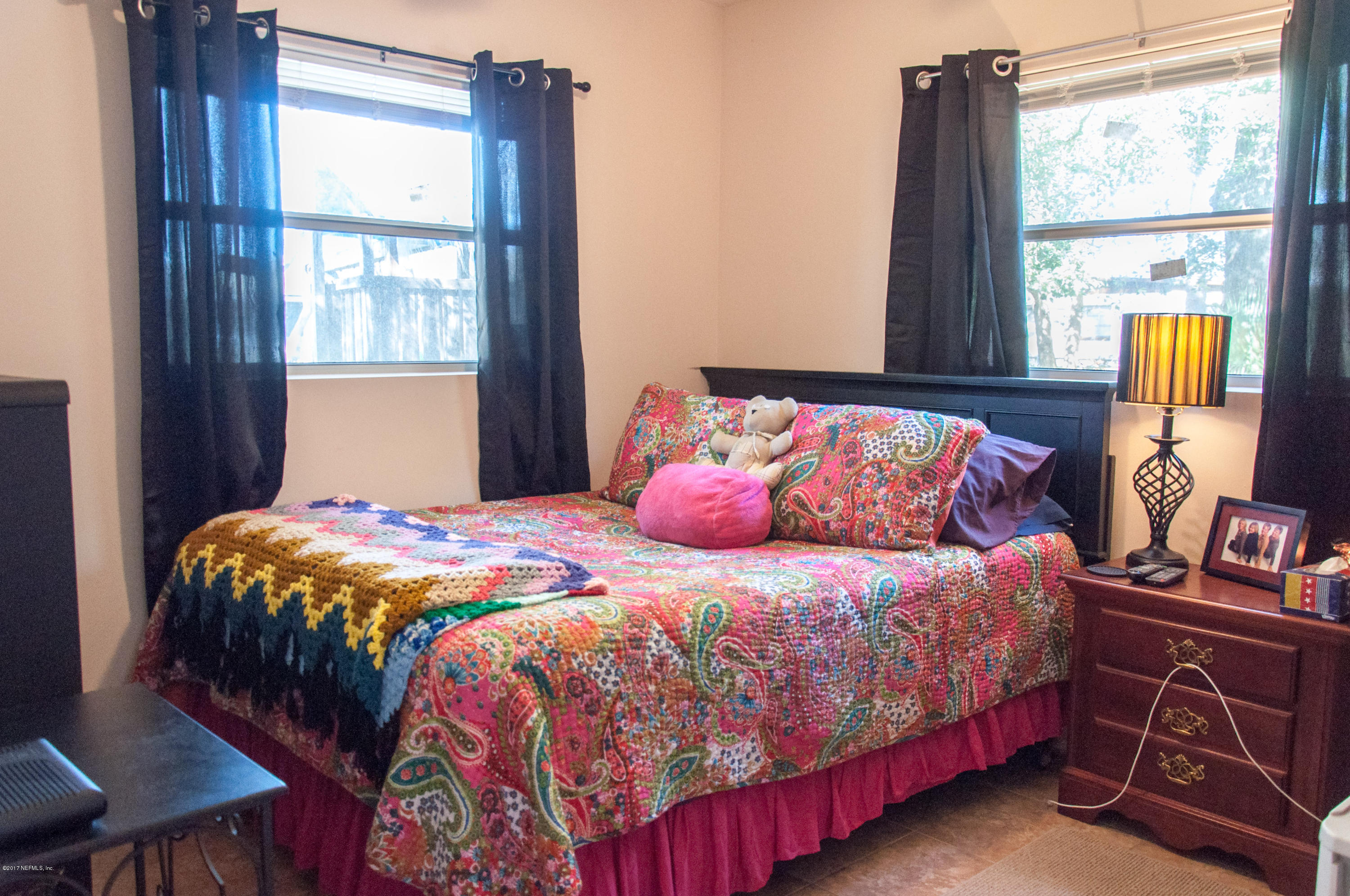 1513 Griflet Road Jacksonville, FL 32211 - Photo 8 of 15 a bedroom with a bed and a window
