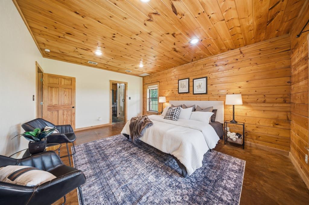 465 Emberson Ranch Road Pilot Point, TX 76258 - Photo 14 of 40 a spacious bedroom with a bed and a couch