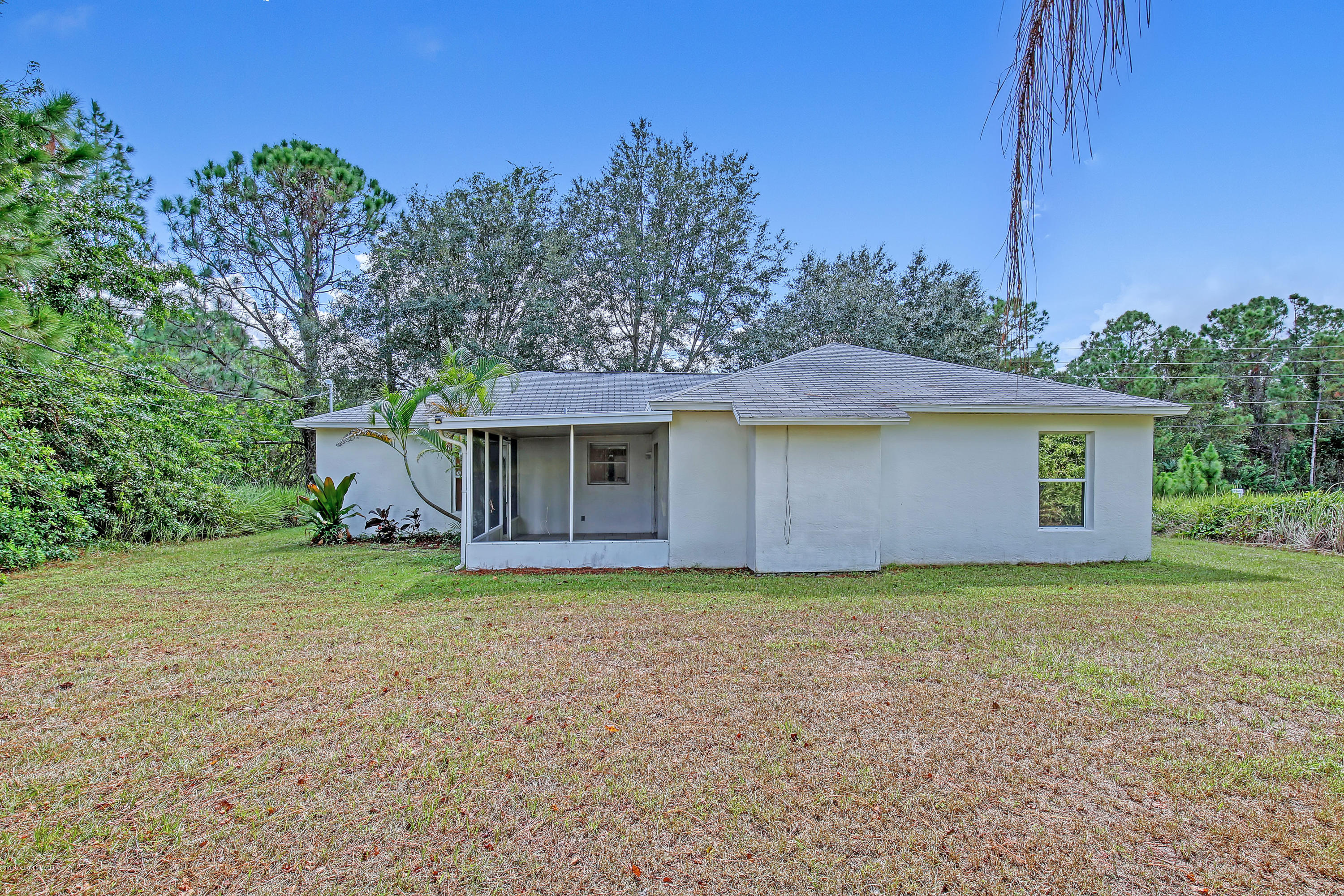 1229 Seabold Road Southwest Palm Bay, FL 32908 - Photo 22 of 24 a front view of a house with a garden