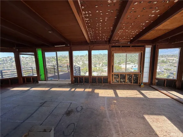 a view of an empty room with a fireplace and a large window