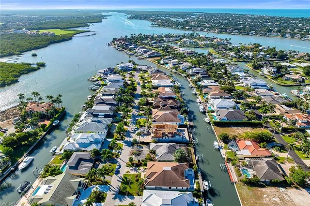 an aerial view of lake and residential houses with outdoor space