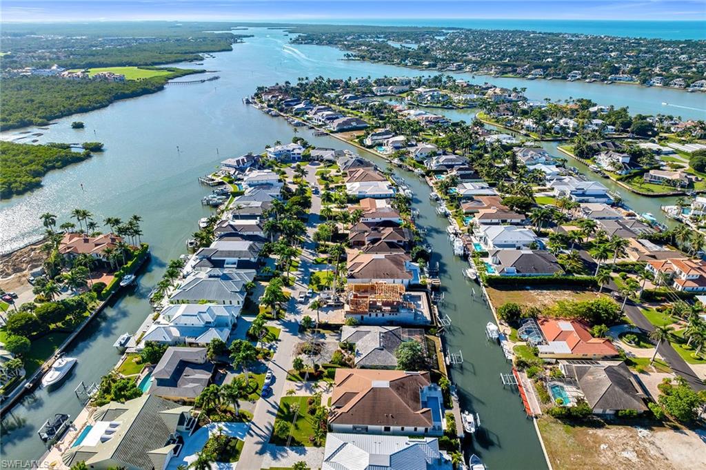 an aerial view of lake and residential houses with outdoor space