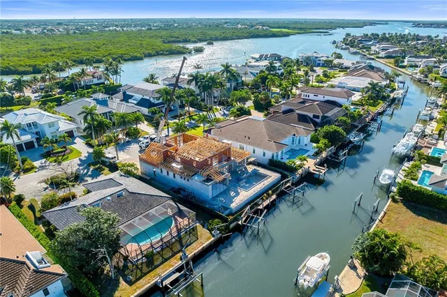 an aerial view of a house yard swimming pool and outdoor seating